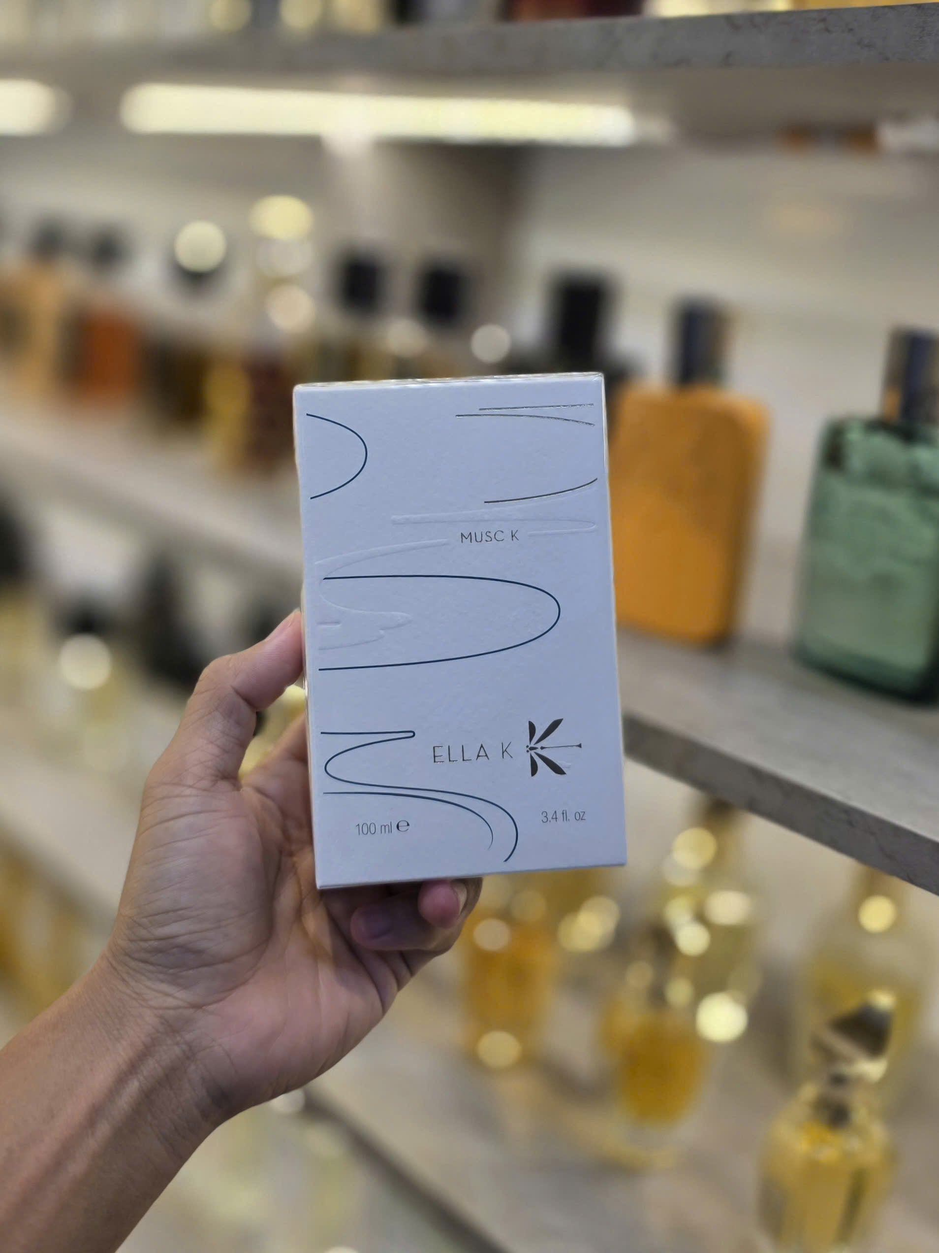 Cận cảnh lọ Musc K tối giản, sang trọng với ánh phản nhẹ.